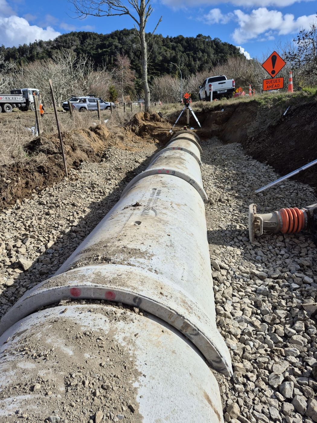 Precast headwall being lifted into a culvert trench