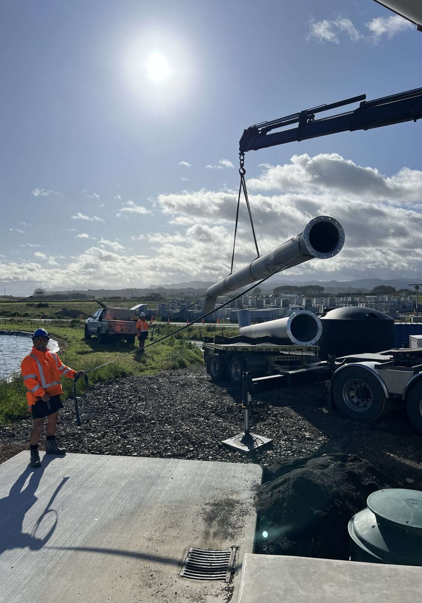 drain pipe being craned with a man watching